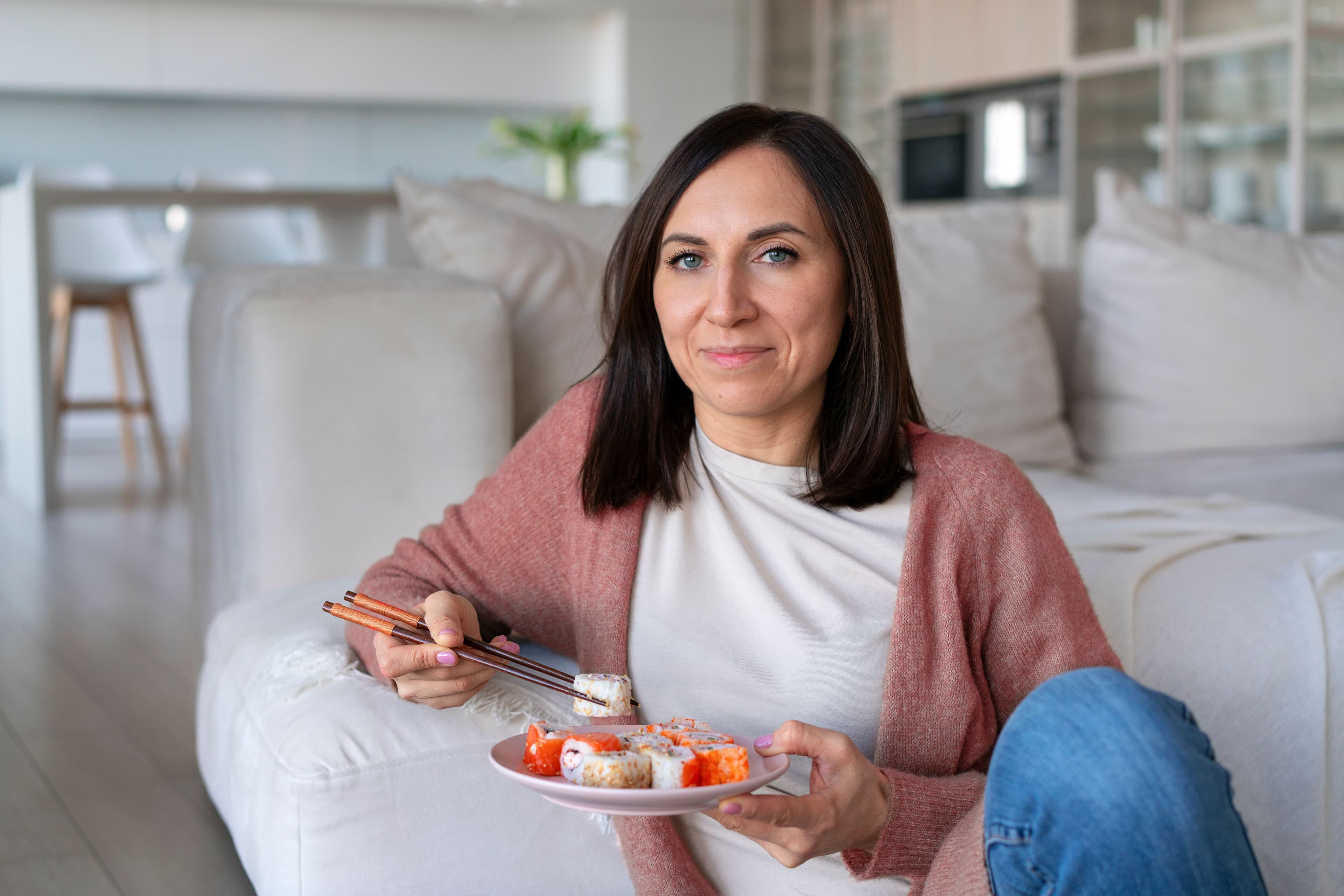 Woman enjoying sushi at home while maintaining a balanced healthy lifestyle